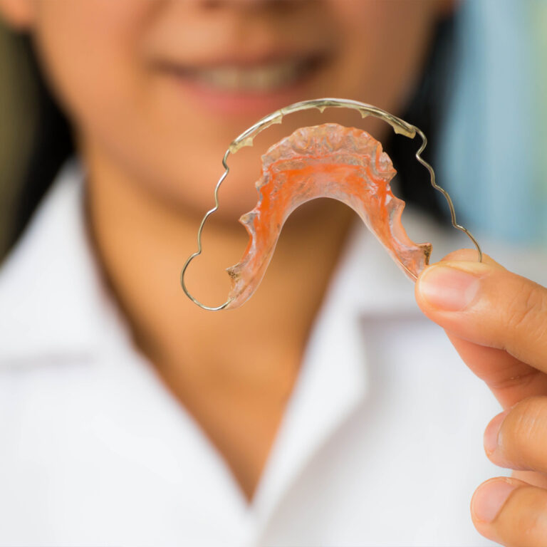 Closeup Of Woman Holding Retainer