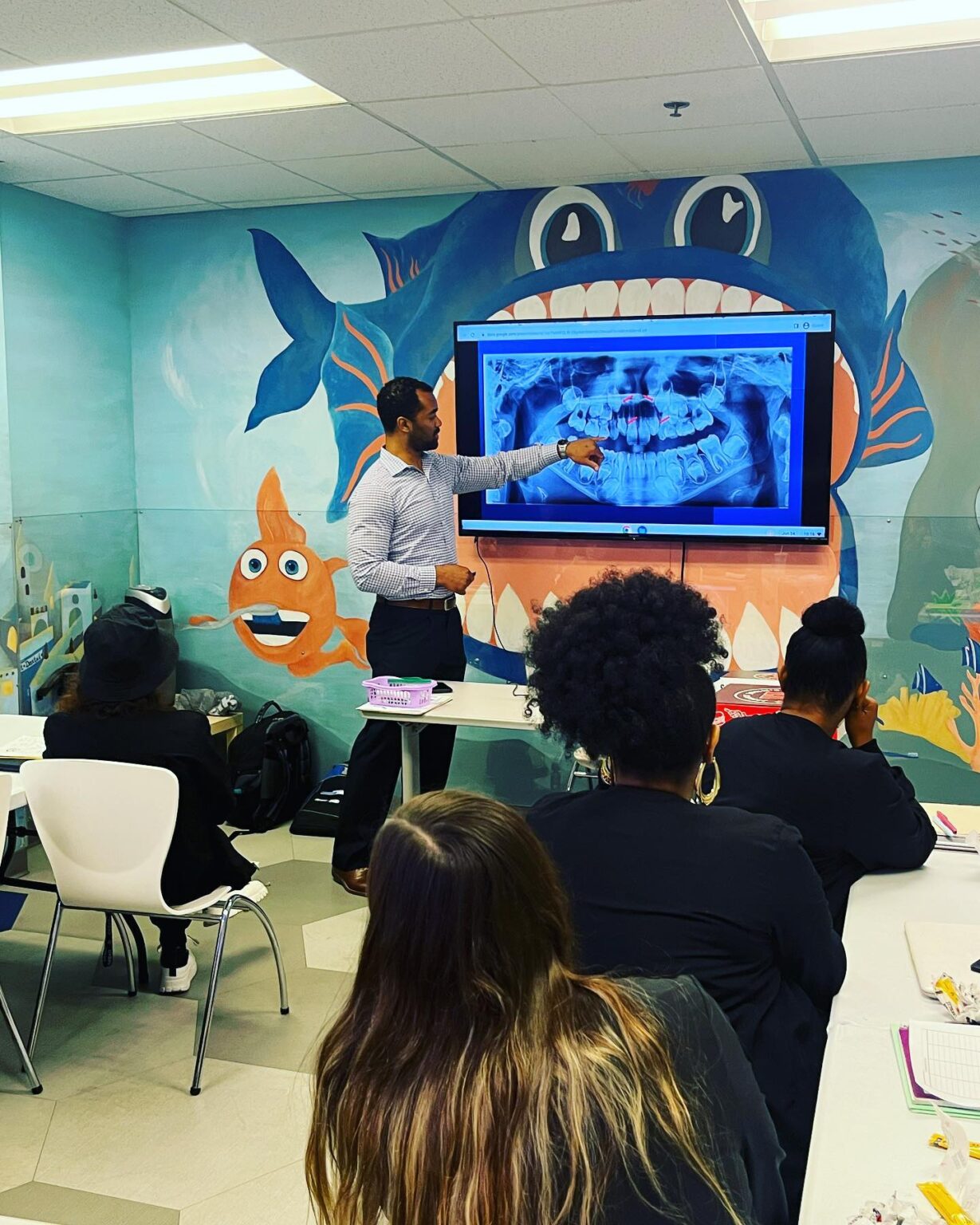 Dr Rohra Teaching Staff By Examining Teeth Xray In Office