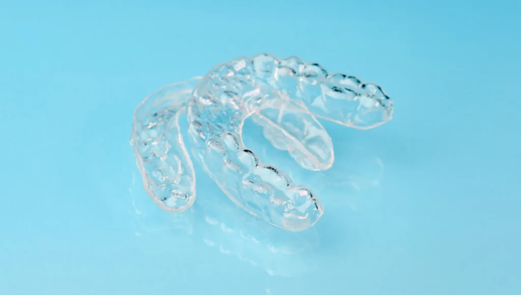 Clear Aligners On A Blue Table