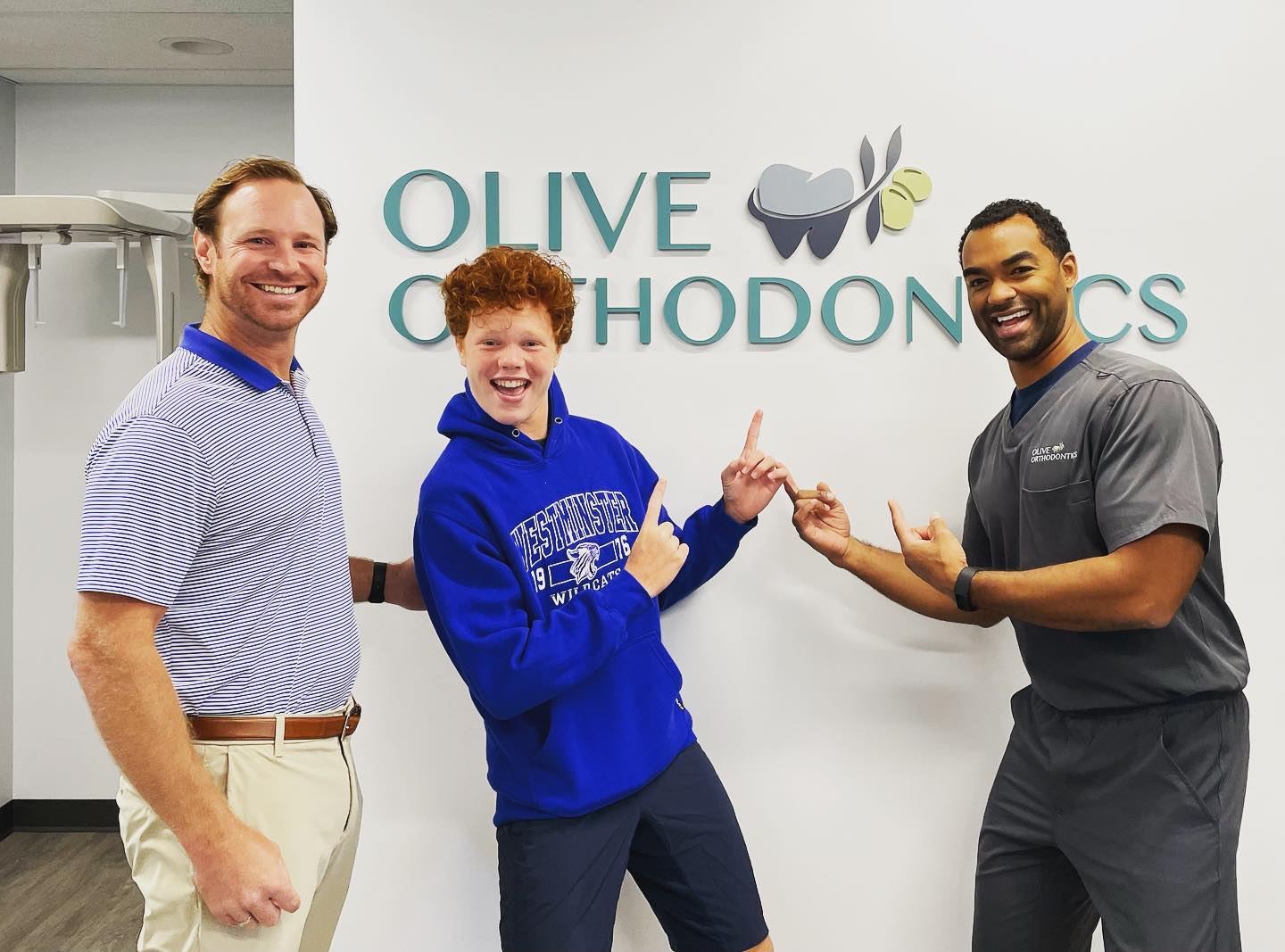 Olive Orthodontics Doctor With Happy Patient In Office